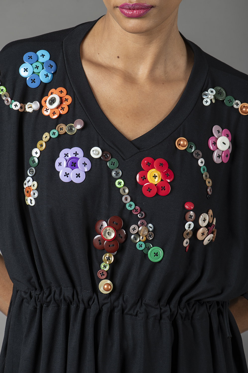 BLUSA PLUS SIZE, COM APLICAÇÃO ARTESANAL DE FLORES DE BOTÃO, BEM SOLTINHA, COM REGULAGEM NA CINTURA, DECOTE V E MANGA CURTA - Imagem 4